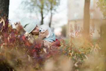 girl hugging and kissing dog
