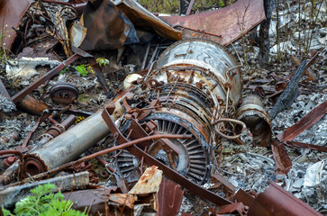Wreckage of a crashed helicopter abandoned in the woods at a scrap metal recycling junkyard....
