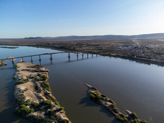 Beautiful bridge over the silver river in the morning sun on the edge of a small town in the interior of northeastern Brazil, Rio São Francisco