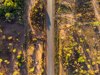 Aerial drone view of road in the middle of the Brazilian savannah, the cerrado, surrounded by low plants
