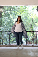 Obraz premium Divorced single Latin adult woman walks and dances in an outdoor park happy, full, calm, fulfilled and at peace 