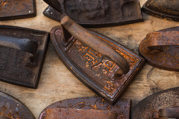 Set of rusty cast iron and steel irons on a flea market