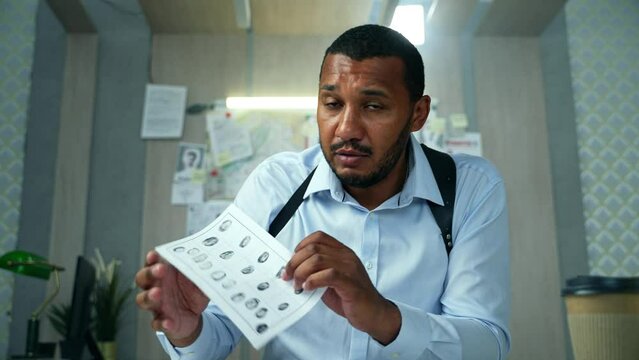 Detective having a video call about investigation with colleagues. Male police officer talking to web camera at laptop while telling the progress of the investigation to authority at police department