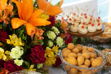 buffet with chicken drumstick and cheese breads, ornamental flowers