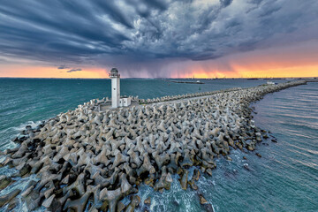 Aerial view of the lighthouse from the entrance to the harbour in Romania, on a stormy day at Black Sea