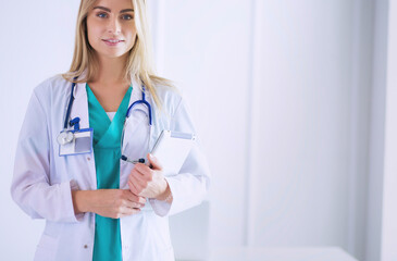 Portrait of confident female doctors standing with arms crossed at the medical office