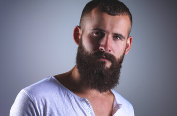 Obraz premium Portrait of handsome bearded man isolated on grey background