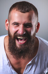 Fototapeta premium Portrait of handsome bearded man isolated on grey background