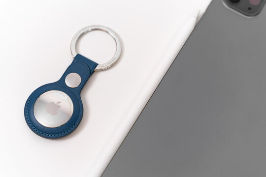 Rostov, Russia - April 04, 2022: Apple Branded iPhone products: AirTags with case of Baltic blue color, iPad and Apple Pencil. Tools for illustrator, freelancer work. 