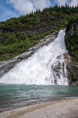Fototapeta premium Views of the Nugget Falls the pours into the glacial lake at Mendenhall glacier.