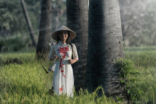 Portrait of Beautiful Asian girls with Ao Dai on Green Rice fields , Vietnam Rice fields prepare the harvest at Northwest Vietnam.Vietnam landscapes.