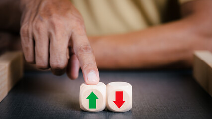 Businessman pointing to a wooden block with green arrow It represents business growth, creative leadership and a distinct business idea. Developing an organizational strategy towards innovation