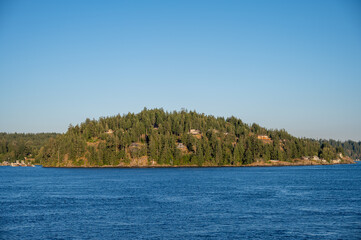 Homes and beautiful landscape on Quadra Island. View from cruise ship.