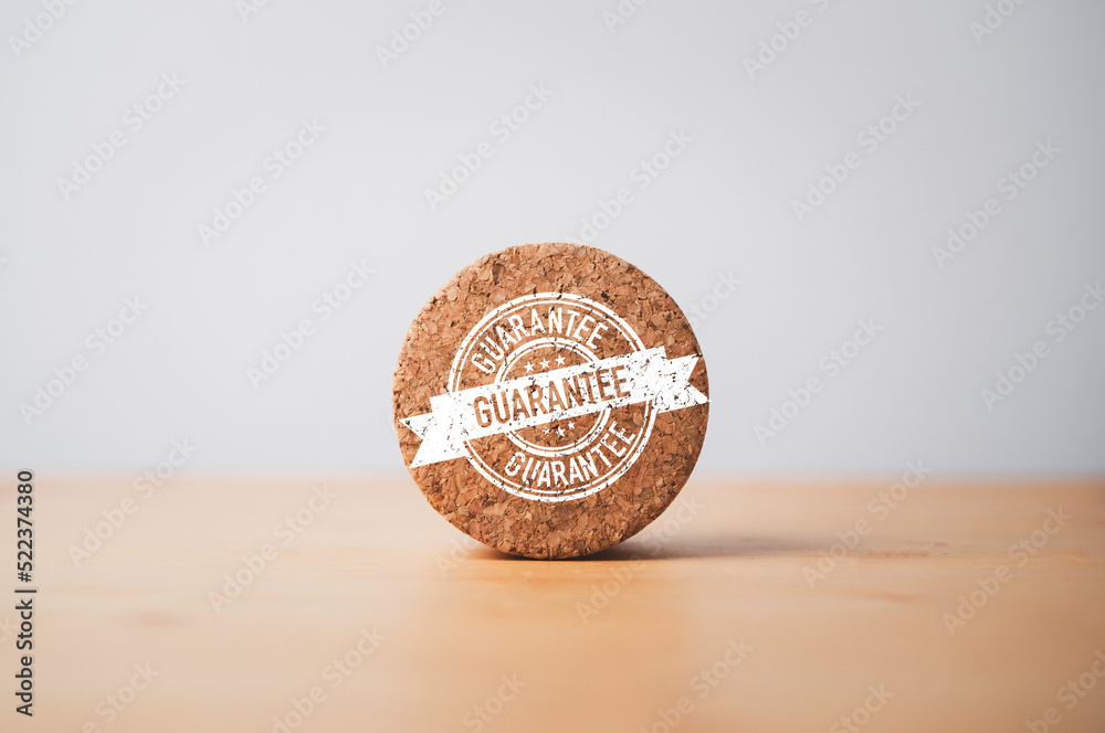 Poster Guarantee label tag print screen on round wooden block for ISO quality standard of product and service , Best quality control assurance and certificate concept.
