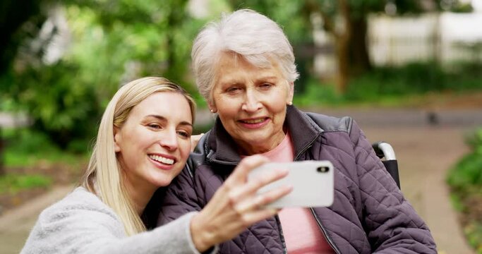 Daughter taking a selfie with her grandmother or disabled senior mother at a park outdoors. Happy, loving and caring young woman making memories on her phone while bonding, spending time with her mom