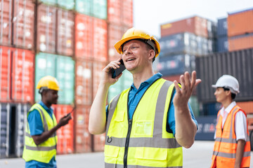 Handsome Caucasian businessman use phone to work in container terminal