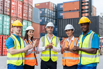Group of man and woman worker clap hands while work in container port. 