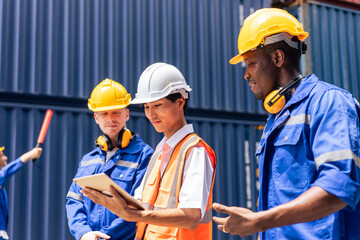 Group of attractive worker male people working in container terminal. 
