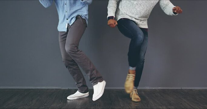 Dancing, funny and excited colleagues having fun and celebrating success at a casual office. Happy and joyful coworkers enjoy victory dance together after getting promotions in a creative company