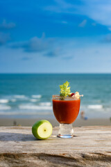 Refreshing cocktail on beach table.