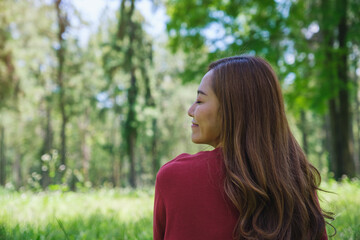 Portrait image of a young woman with closed eyes enjoying and relaxing in the park