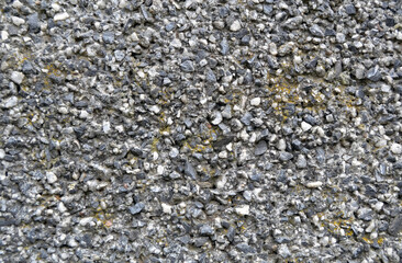 Gray pebbles and cement wall texture, beach sandstone background