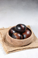 Telur asin Bakar or Asap or Smoked salted egg, food culinary from indonesia, black color smoked salted 