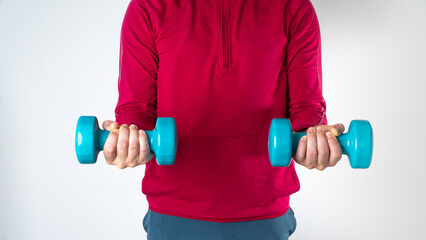 Athletic man with dumbbells in his hands for training