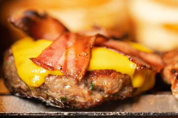 Close up view of a cheeseburger with bacon on the top