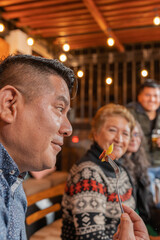 Profile of a man eating fast food with her family in a restaurant