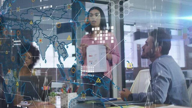Animation of data processing over world map against diverse businesspeople discussing at office - Powered by Adobe