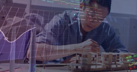 Animation of stock market data processing over asian male engineer working on his model at office - Powered by Adobe