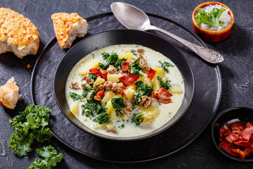 Zuppa Toscana,Tuscan Soup in black bowl, top view