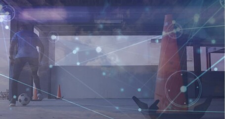 Animation of network of connections against african american male soccer player practicing - Powered by Adobe