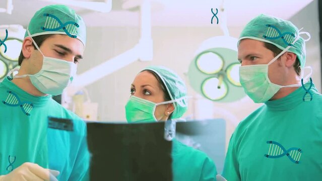 Animation of multiple dna structures over team of diverse surgeons discussing at hospital