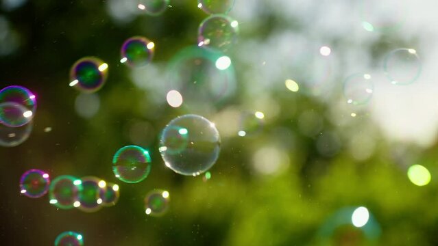 Blowing colorful bubbles in nature