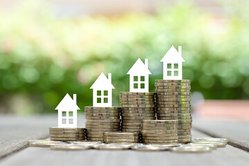 Real estate concept. Choosing the right real estate, house on coin stack. investment opportunity...