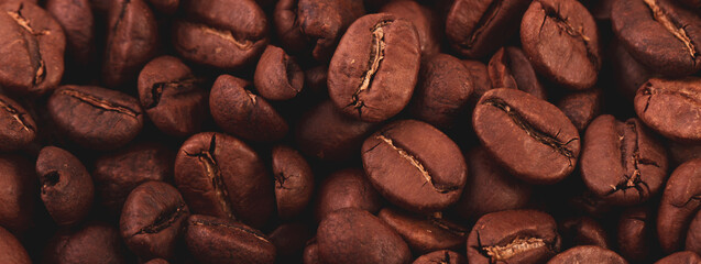 Coffee lover view of roasted coffee beans for background and texture. Dumped roasted coffee beans...