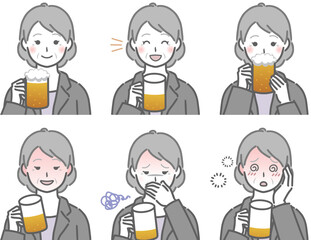 お酒を飲むスーツの高齢女性