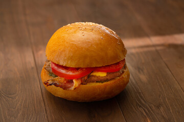 hamburger with bacon on a wooden table