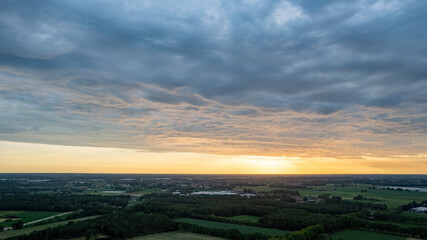 Aerial view, shot by a drone of a sunset at coast of the lake. Nature landscape. Nature in northern Europe. reflection, blue sky and yellow sunlight. landscape during sunset. High quality photo
