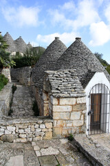 Fototapeta na wymiar A Trulli village with a lot of traditional stone houses in Alberrobello, Apulia, Italy