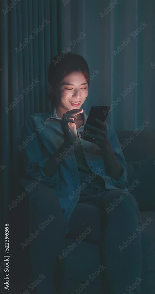 Poster woman using phone at night