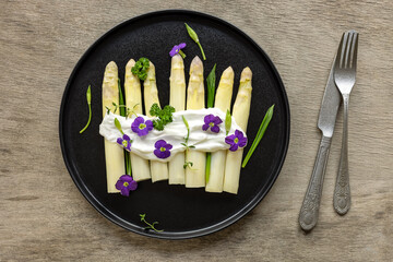 German White Asparagus with sauce, wild garlic, and edible flowers. Great dietary food, seasonal...