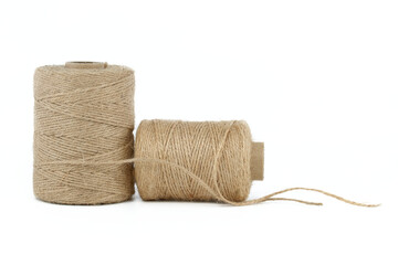 Natural burlap threads or jute twine rolls over white