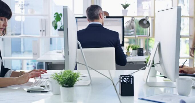 Teamwork, thinking and planning between a creative team collaborating on a project in a modern office. Web designers sharing an idea or vision, discussing and helping with a strategy for a proposal