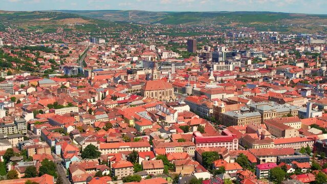 Aerial drone view of Cluj centre, Romania. Cityscape, roads with cars, old buildings, Saint Michael Church