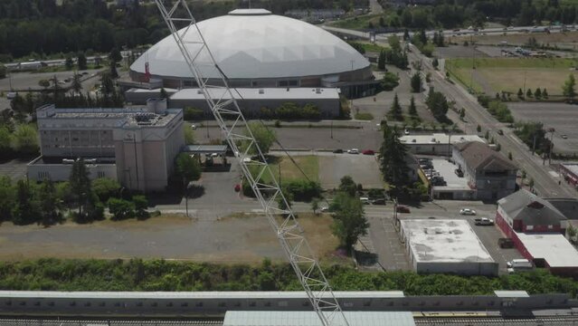 Tacoma Dome Behind Towering Leavitt Cranes In Tacoma Downtown, Washington, United States. Aerial Tilt-down Shot
