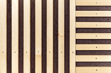 Building wall decorated with stylish wooden slats made of thin light planks on house terrace extreme close view