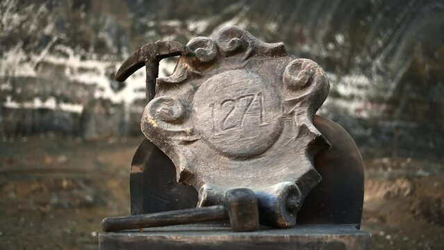 Salina Turda salt mine in Romania. Monument with a pickaxe and 1271 inscription